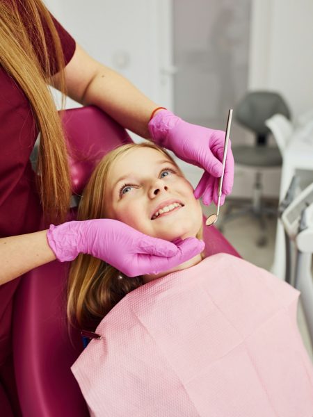 Little girl visiting dentist in clinic. Conception of stomatology